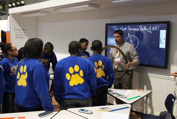 A teacher invites students to examine a bike tire while discussing Pi.