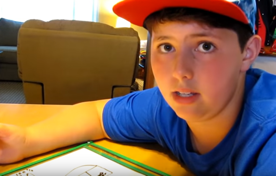 Tucker looks at the camera while explaining his worksheet.